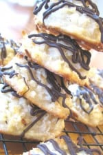 A stack of Chocolate Drizzled Macaroons on a wire cooling rack.