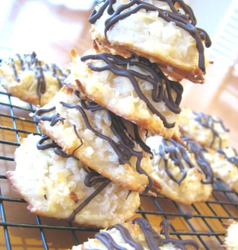 A stack of Chocolate Drizzled Macaroons on a wire cooling rack.