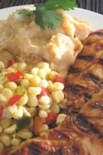 A plate of Sweet Sautéed Corn, Smoky Mashed Potatoes, and Adobo Peach BBQ Chicken.