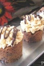 A tray of Chocolate Chip Cookie Cup Treats with a marshmallow-rice crispy topping and a drizzle of chocolate