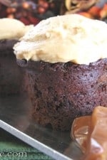 A few Chocolate Cinnamon Mini Cakes topped with fluffy Caramel Buttercream next to a pile of caramel.