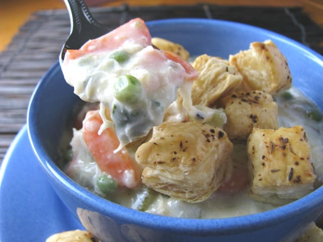 A bowl of Chicken Pot Pie Soup with Puffy Croutons