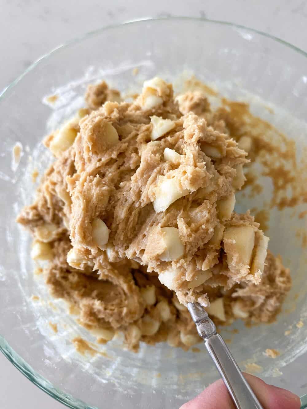 Mixing White Chocolate Chips into the Peanut Butter Apple Cookie Dough