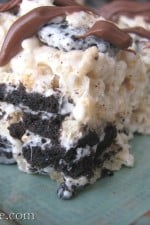 A Cookies and Cream Rice Krispie Treat filled with Oreos and drizzled with chocolate.
