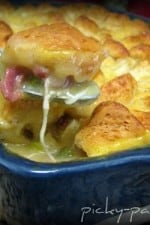 Casserole dish full of biscuit topped chicken pot pie.
