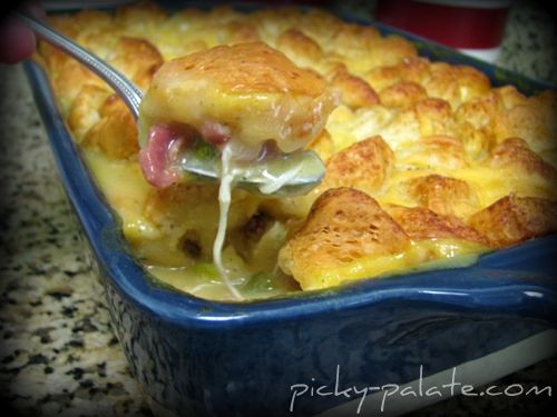Casserole dish full of biscuit topped chicken pot pie.