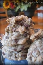 A stack of secret ingredient chocolate chip cookies crispers with a bite taken out of one of the cookies.