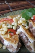 Plate of steak quesadillas with corn and tomato relish.