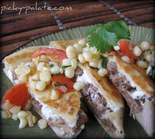 Plate of steak quesadillas with corn and tomato relish.