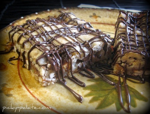 A Crunchy Reese's Cookie Bar topped with drizzled melted chocolate.