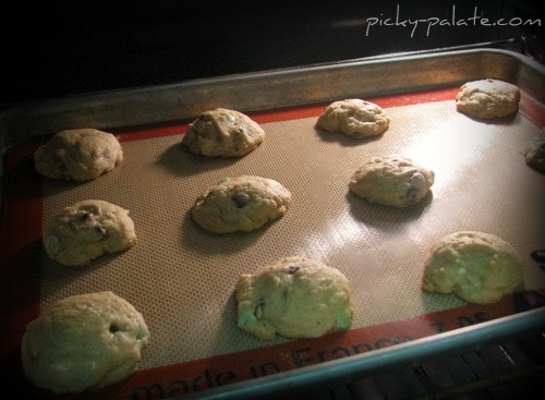 Mint chocolate chip cookies baking in the oven.