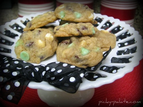 An assortment of mint chocolate chip cookies on a cake stand.