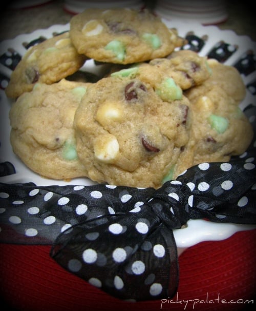 An assortment of mint chocolate chip cookies on a cake stand.