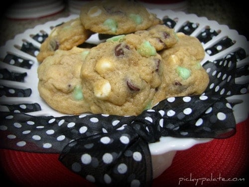 An assortment of mint chocolate chip cookies on a cake stand.