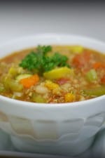 A bowl of Chunky Vegetable Quinoa Chili with a spoon.