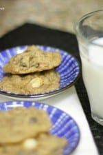 Two plates each with two Caramel Apple Chocolate Chip Cookies next to a glass of milk
