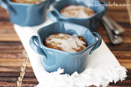 A few mini loaves in blue pots of caramel hazelnut banana bread topped with a white sweet vanilla icing