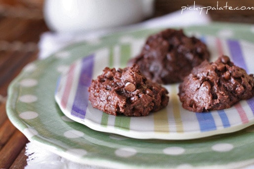 Three Double Chocolate Brownie Cookies on a colorful striped platter.