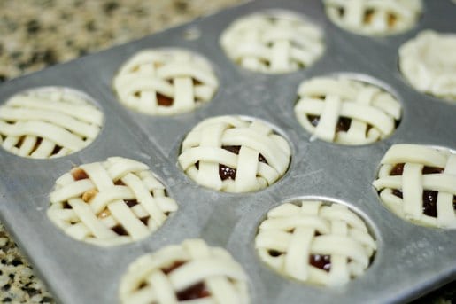 Peanut butter and jelly mini pies with lattice crusts in a mini muffin tin.