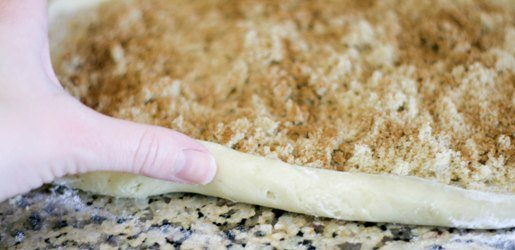 roll Cinnamon Roll Sugar Cookie dough into a log to cut into slices