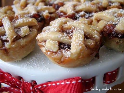 Close up of peanut butter and jelly mini pies on a cake stand.