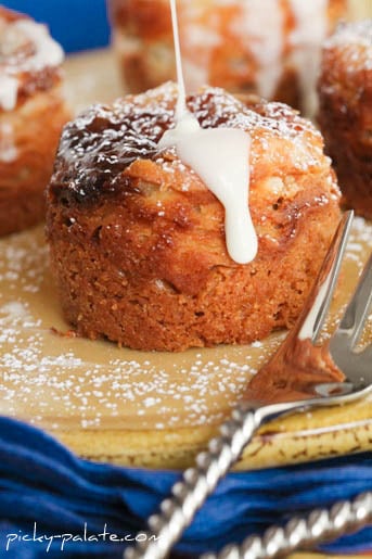 Close up of a peanut butter and jelly cheesecake bite being drizzled with vanilla glaze.