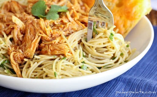 A Bowl of BBQ Chicken Spaghetti on a Blue Cloth Placemat