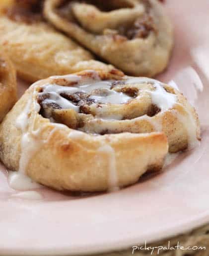 Roasted Banana Cinnamon Rolls on a plate with icing.