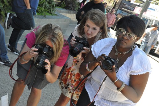 Three Women Taking Photos with Digital Cameras