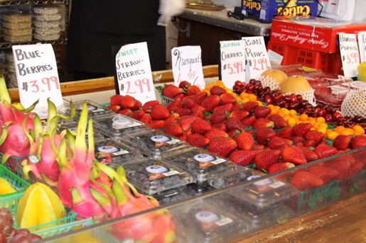 A Farmer's Market Fruit Stand with Blueberries, Pears, Cherries and Other Fruits