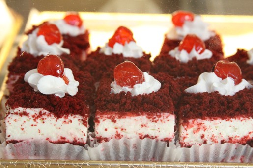 Eight Cherry Cheesecake Squares in a Pastry Display