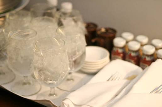 Wine Glasses Arranged Beside Neatly Folded Silverware