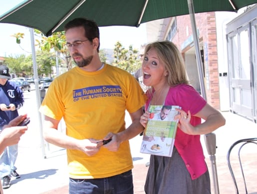 Jenny Holding Tal's Cookbook While Standing Beside Him