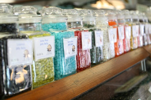 A Shelf of Jars of Different Flavored Jelly Belly Candies