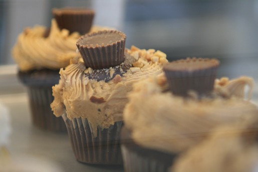 Four Chocolate and Peanut Butter Cup Cupcakes Arranged in a Line