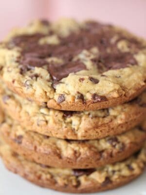 Stack of four chocolate chunk cookies with salted caramel.