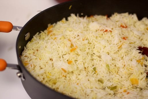 A layer of Mexican rice in a skillet.