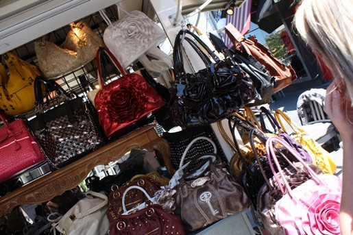 A Bunch of Colorful Bags and Handbags at a Purse Kiosk