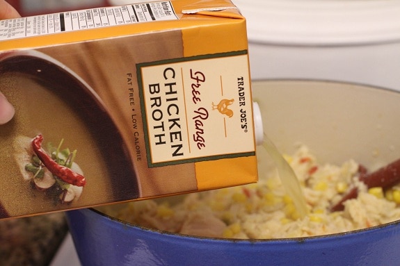 Chicken Broth Being Poured Into the Pot with the Chicken Mixture