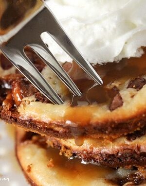 Snickers Caramel Cheesecake Cookies in a stack on a plate.
