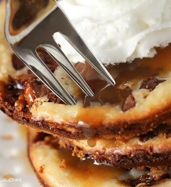 Snickers Caramel Cheesecake Cookies in a stack on a plate.