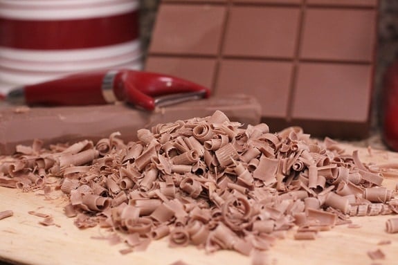 Chocolate shavings with a grater in the background.