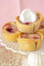 Lemon Raspberry Baby Cheesecake Pies in a stack on a plate