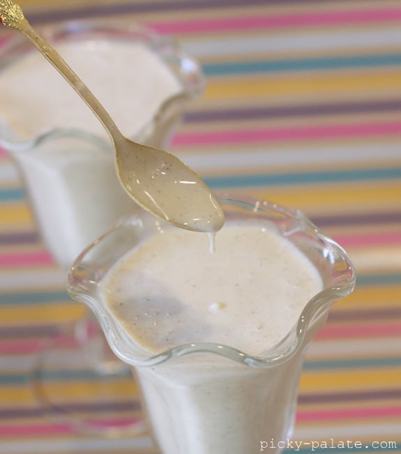 A Spoon Digging into a Fresh Banana Bread Milkshake