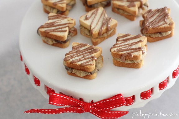 Mini chocolate chip sandwiches drizzled with chocolate on a cookie platter.