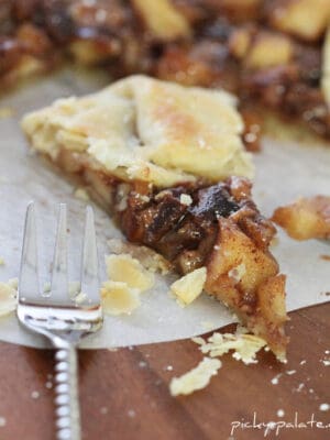 A slice of Chocolate & Apple Pie Galette with a bite taken out and a fork next to the slice.