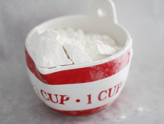 A measuring cup filled with flour.