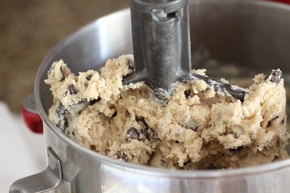 Chocolate chip cookie dough in a stand mixer.