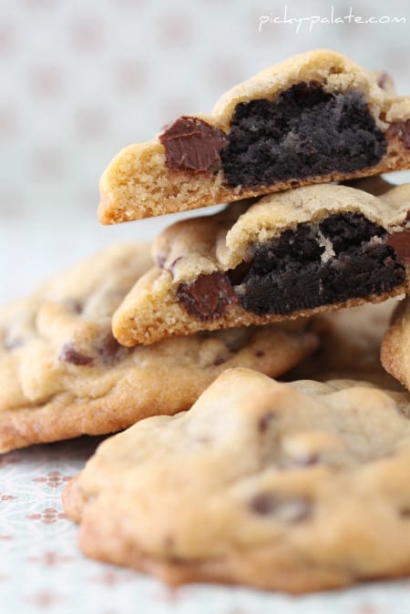 Oreo truffle surprise cookies stacked, with a cookie broken in half to show an Oreo truffle center.