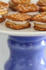 PB and J pretzel sandwiches on a pedestal serving tray.